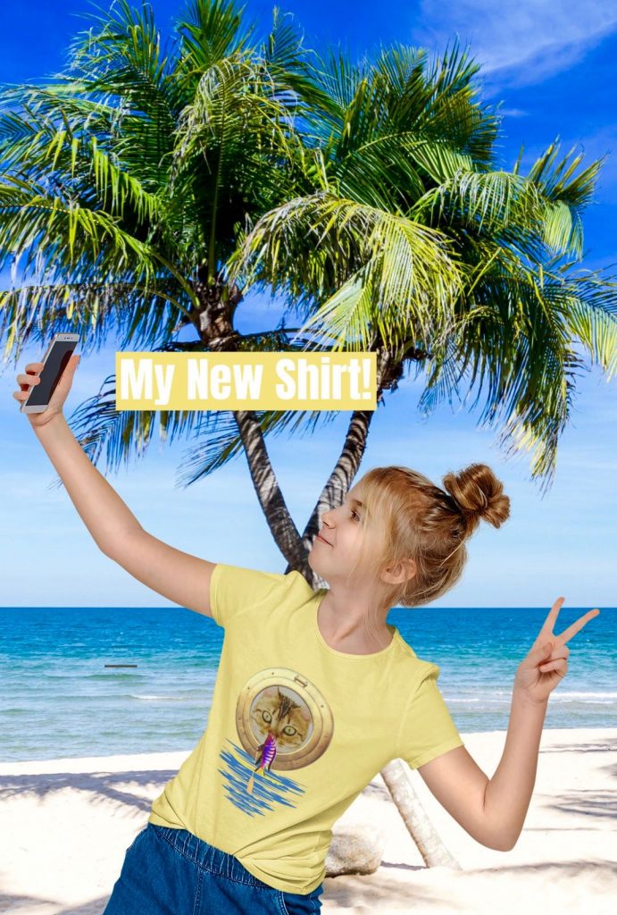 Girl makes selfie on the beach with new t-shirt. Funny cute cat and fish on SUP board gift idea present
